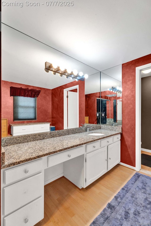 6611 Windmill Ln, West Bloomfield, MI 48324 - bathroom with wood finished floors and vanity