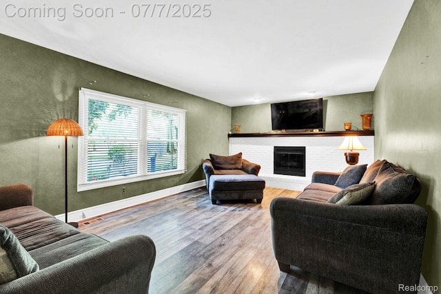 6611 Windmill Ln, West Bloomfield, MI 48324 - living room featuring wood finished floors and a fireplace