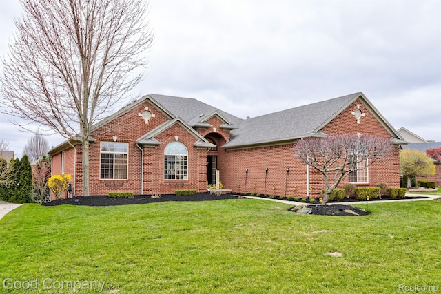 63705 Monticello E, Washington, MI 48095 - view of front of home with brick siding, a front yard, and a shingled roof