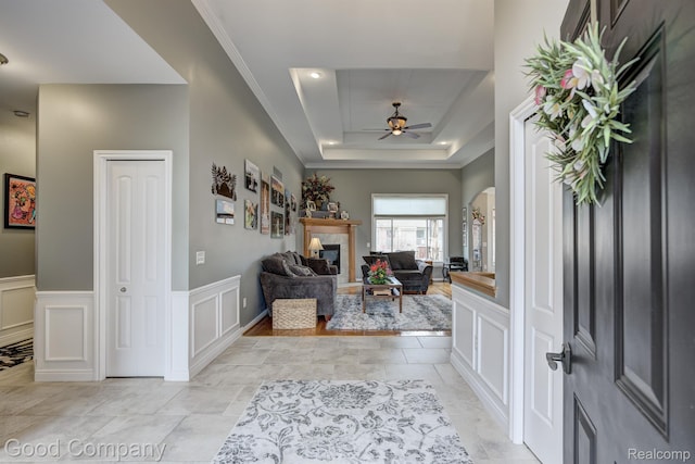 63705 Monticello E, Washington, MI 48095 - entryway with a ceiling fan, a decorative wall, arched walkways, a raised ceiling, and wainscoting