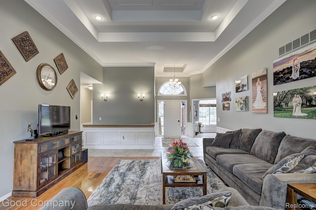 63705 Monticello E, Washington, MI 48095 - living room featuring a tray ceiling, light wood finished floors, and crown molding