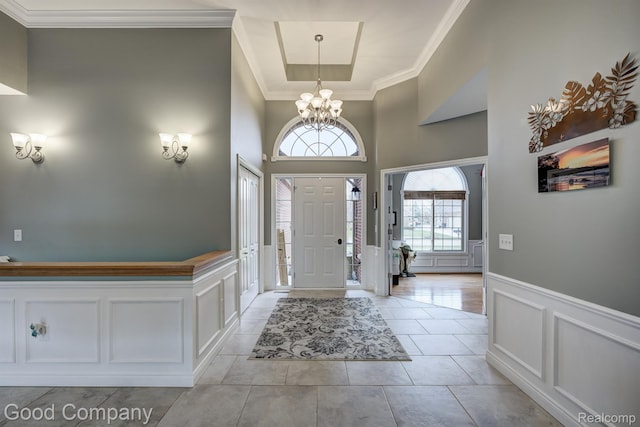 63705 Monticello E, Washington, MI 48095 - entryway with a decorative wall, ornamental molding, a chandelier, wainscoting, and light tile patterned floors