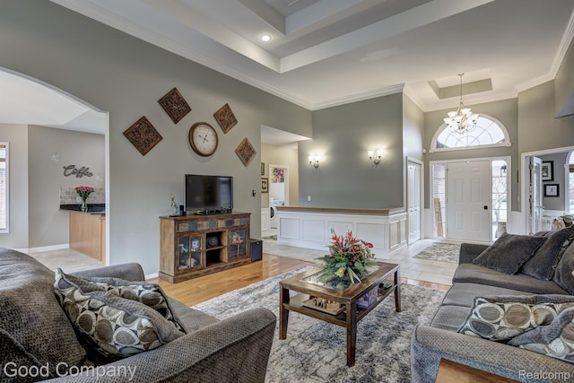 63705 Monticello E, Washington, MI 48095 - living area with a high ceiling, crown molding, a chandelier, a tray ceiling, and recessed lighting