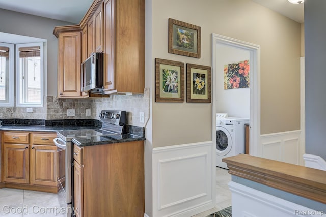 63705 Monticello E, Washington, MI 48095 - kitchen with appliances with stainless steel finishes, brown cabinets, independent washer and dryer, a wainscoted wall, and a decorative wall