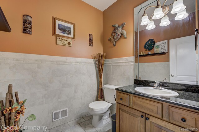 63705 Monticello E, Washington, MI 48095 - bathroom with vanity, tile walls, tile patterned flooring, wainscoting, and a chandelier