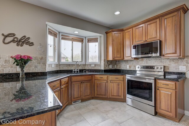 63705 Monticello E, Washington, MI 48095 - kitchen with appliances with stainless steel finishes, brown cabinets, and recessed lighting
