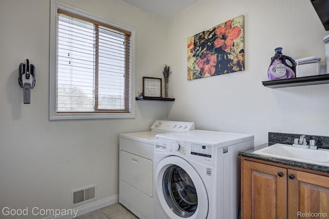 63705 Monticello E, Washington, MI 48095 - laundry room with separate washer and dryer, healthy amount of natural light, cabinet space, and light tile patterned floors