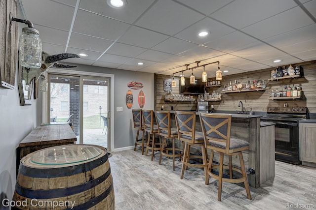 63705 Monticello E, Washington, MI 48095 - indoor wet bar with black range with electric stovetop, light wood finished floors, recessed lighting, and a drop ceiling