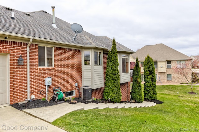 63705 Monticello E, Washington, MI 48095 - back of house with brick siding, a lawn, and a shingled roof