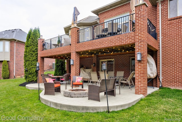 63705 Monticello E, Washington, MI 48095 - back of property with a balcony, a fire pit, a patio area, and brick siding