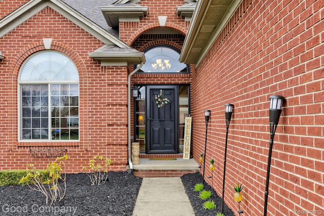 63705 Monticello E, Washington, MI 48095 - view of exterior entry with brick siding and roof with shingles