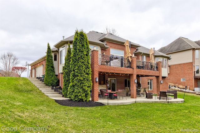 63705 Monticello E, Washington, MI 48095 - rear view of house with brick siding, a patio area, a lawn, a balcony, and an attached garage
