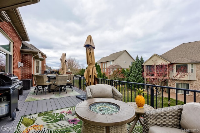 63705 Monticello E, Washington, MI 48095 - wooden deck with an outdoor fire pit, outdoor dining area, and a grill