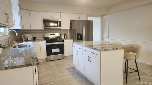 28230 Sutherland Dr, Warren, MI 48088 - kitchen featuring stainless steel appliances, a breakfast bar, light stone countertops, and tasteful backsplash