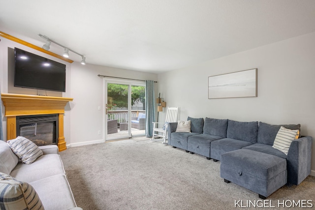 340 S Lake Ave, Spring Lake, MI 49456 - living room featuring track lighting, a glass covered fireplace, and carpet