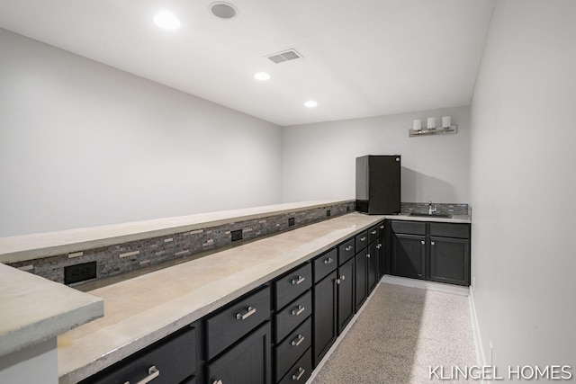 340 S Lake Ave, Spring Lake, MI 49456 - kitchen with light countertops, recessed lighting, dark speckled floor, and dark cabinets