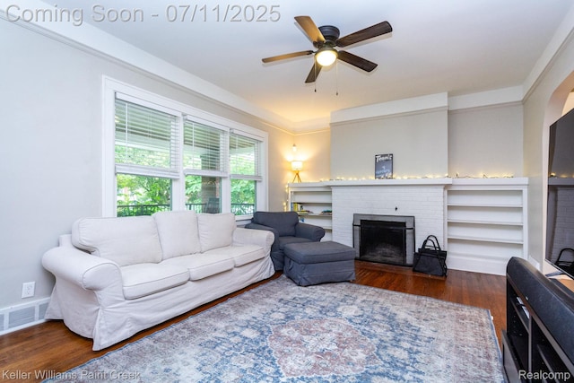 1424 Lakepointe St, Detroit, MI 48230 - living room with wood finished floors, a ceiling fan, and a brick fireplace