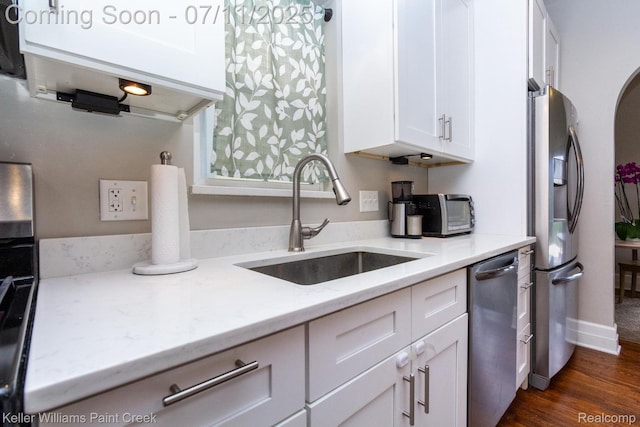 1424 Lakepointe St, Detroit, MI 48230 - kitchen featuring appliances with stainless steel finishes, white cabinets, light stone counters, and dark wood finished floors