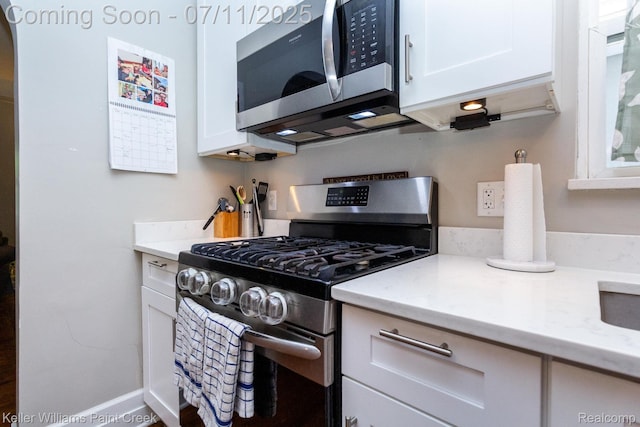 1424 Lakepointe St, Detroit, MI 48230 - kitchen with appliances with stainless steel finishes, white cabinetry, and light stone counters