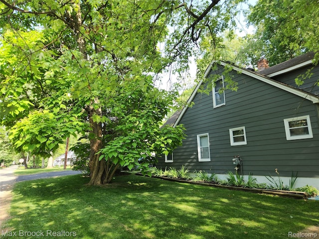3705 Sancroft Ave, West Bloomfield, MI 48324 - view of side of property with a chimney and a lawn