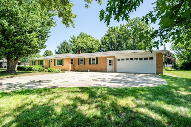 3813 Green Acre Dr, Saint Joseph, MI 49085 - single story home with a front yard, concrete driveway, a garage, and brick siding