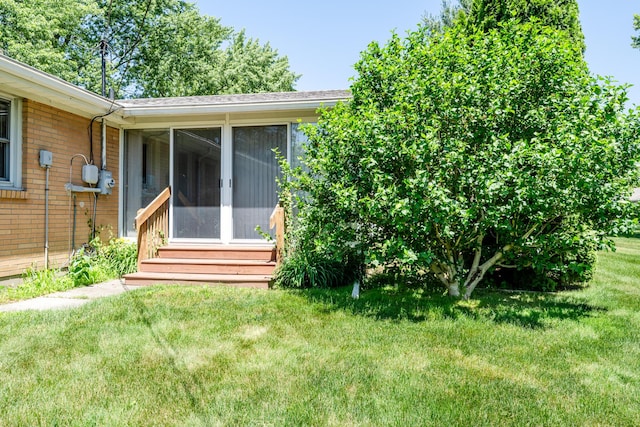 3813 Green Acre Dr, Saint Joseph, MI 49085 - view of green lawn with a sunroom and entry steps