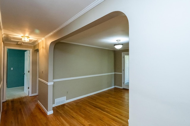 3813 Green Acre Dr, Saint Joseph, MI 49085 - spare room featuring wood finished floors, arched walkways, and ornamental molding