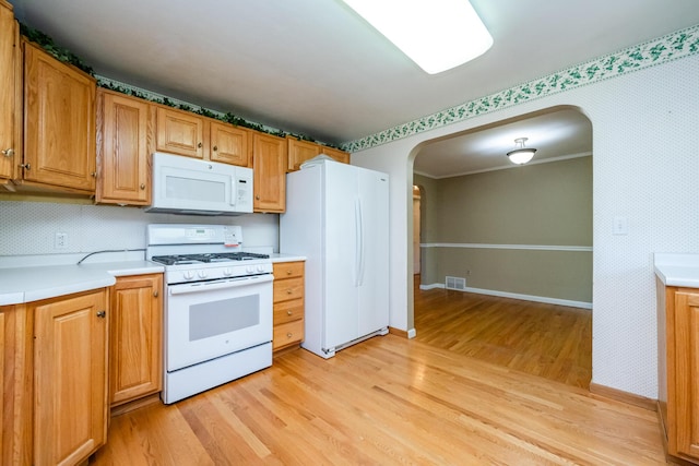 3813 Green Acre Dr, Saint Joseph, MI 49085 - kitchen with white appliances, arched walkways, light wood finished floors, and light countertops