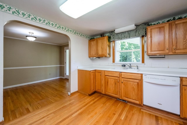 3813 Green Acre Dr, Saint Joseph, MI 49085 - kitchen with dishwasher, arched walkways, light wood-style floors, brown cabinetry, and light countertops