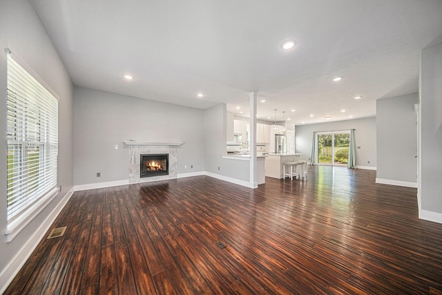 2807 Bartlett Rd, Pleasant Lake, MI 49272 - unfurnished living room with dark wood-style floors, a lit fireplace, and recessed lighting