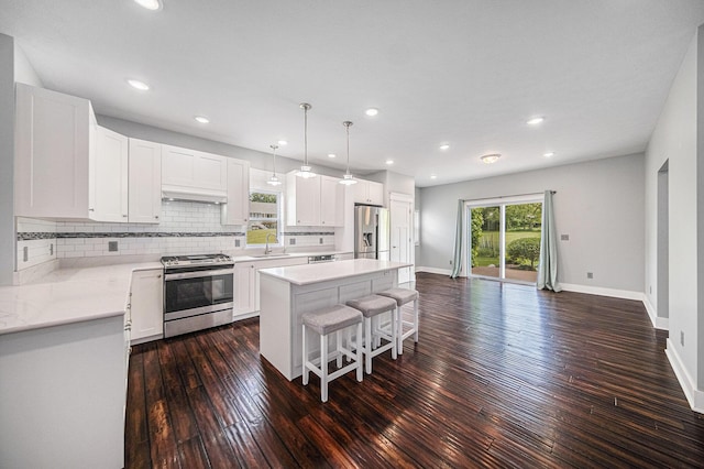 2807 Bartlett Rd, Pleasant Lake, MI 49272 - kitchen featuring appliances with stainless steel finishes, dark wood-style flooring, a kitchen breakfast bar, a kitchen island, and recessed lighting