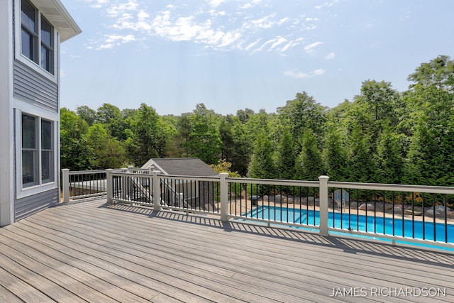 12974 Boulderway Trl, Grand Haven, MI 49417 - deck featuring an outdoor pool and an outbuilding