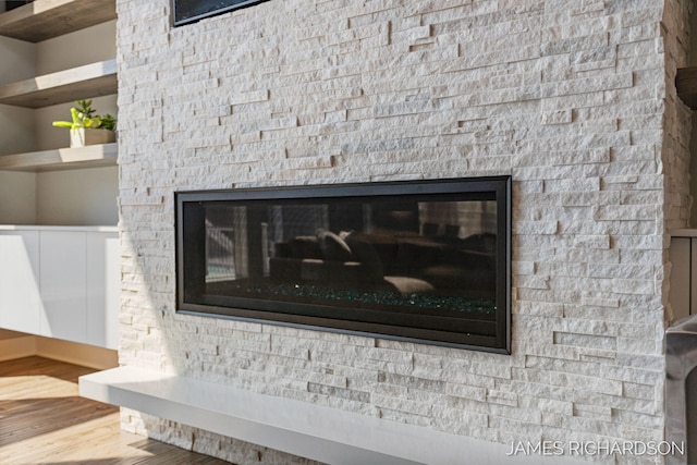 12974 Boulderway Trl, Grand Haven, MI 49417 - detailed view of a stone fireplace and wood finished floors