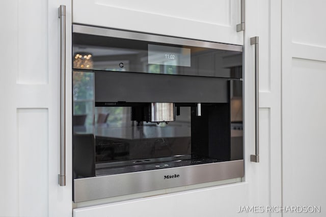 12974 Boulderway Trl, Grand Haven, MI 49417 - detailed view of backsplash and white cabinetry