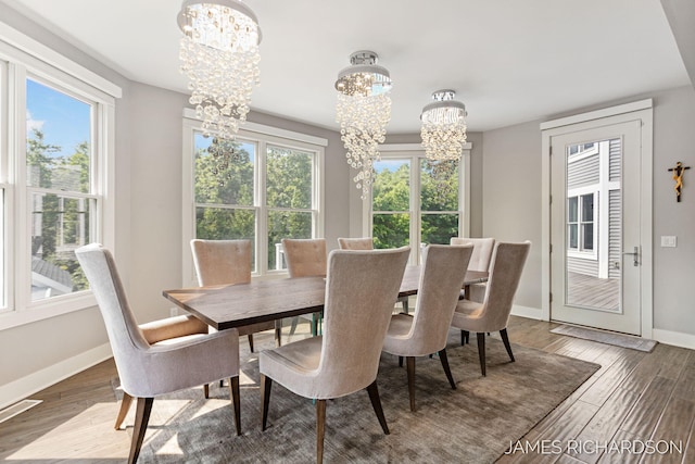 12974 Boulderway Trl, Grand Haven, MI 49417 - dining room with a chandelier and wood finished floors