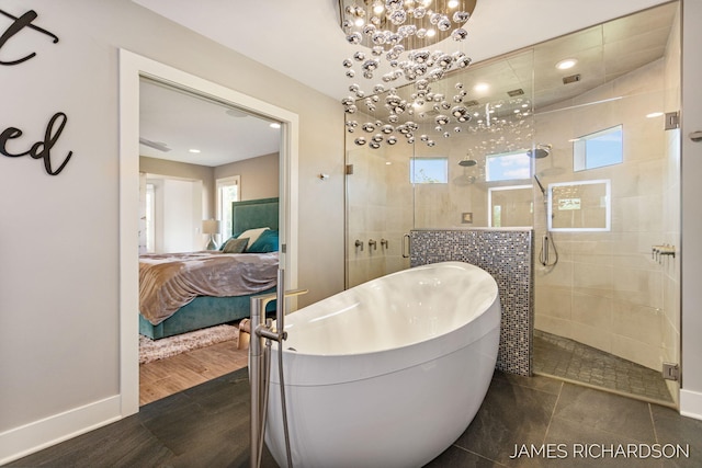 12974 Boulderway Trl, Grand Haven, MI 49417 - full bath featuring connected bathroom, a tile shower, a freestanding bath, and a chandelier