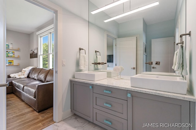 12974 Boulderway Trl, Grand Haven, MI 49417 - full bath featuring double vanity, connected bathroom, and marble finish floors