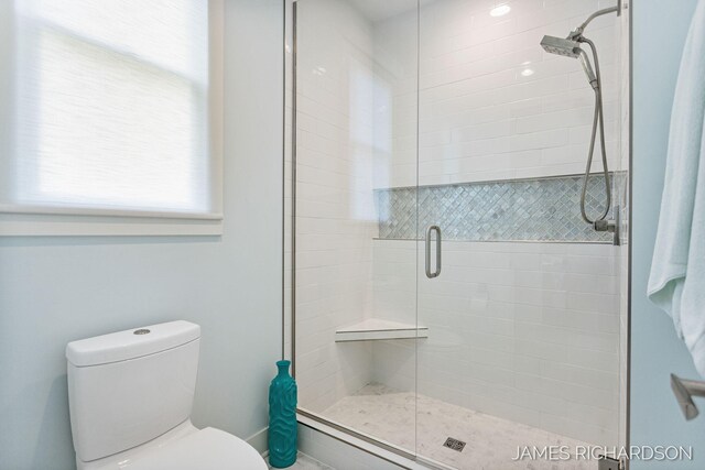 12974 Boulderway Trl, Grand Haven, MI 49417 - bathroom featuring a stall shower and toilet