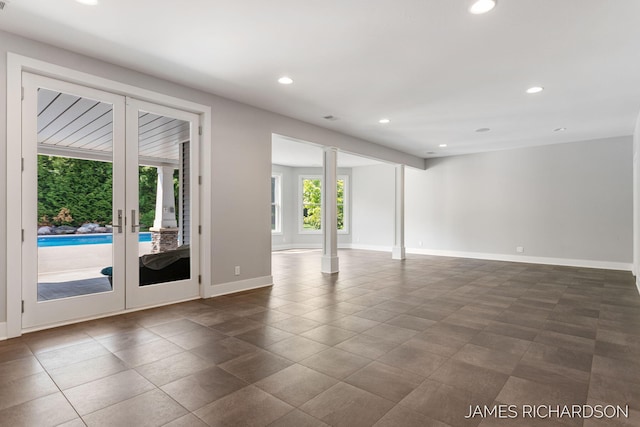 12974 Boulderway Trl, Grand Haven, MI 49417 - spare room with recessed lighting, french doors, and dark tile patterned flooring