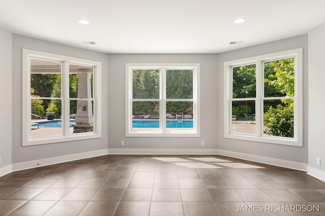 12974 Boulderway Trl, Grand Haven, MI 49417 - unfurnished room featuring healthy amount of natural light, recessed lighting, and dark tile patterned floors