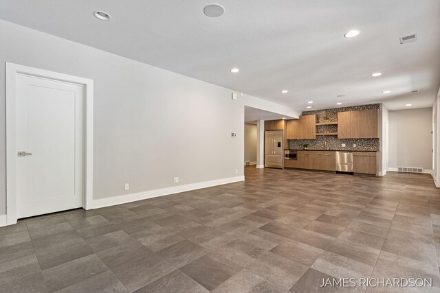 12974 Boulderway Trl, Grand Haven, MI 49417 - unfurnished living room featuring recessed lighting and baseboards