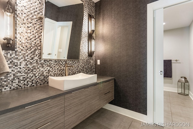 12974 Boulderway Trl, Grand Haven, MI 49417 - bathroom featuring vanity, tile patterned flooring, and backsplash