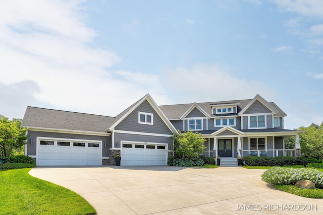 12974 Boulderway Trl, Grand Haven, MI 49417 - view of front of property featuring stone siding, concrete driveway, a porch, and an attached garage