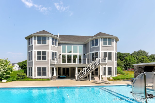 12974 Boulderway Trl, Grand Haven, MI 49417 - outdoor pool featuring a patio area, stairs, a water slide, and a sunroom