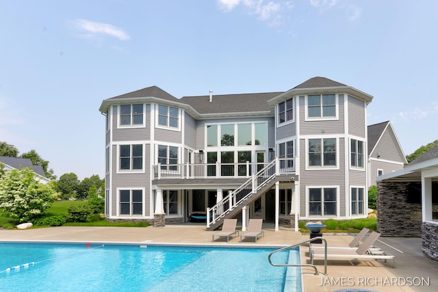 12974 Boulderway Trl, Grand Haven, MI 49417 - rear view of property with stairway, a patio area, an outdoor pool, and a deck