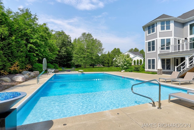 12974 Boulderway Trl, Grand Haven, MI 49417 - swimming pool with a patio, a diving board, and stairway