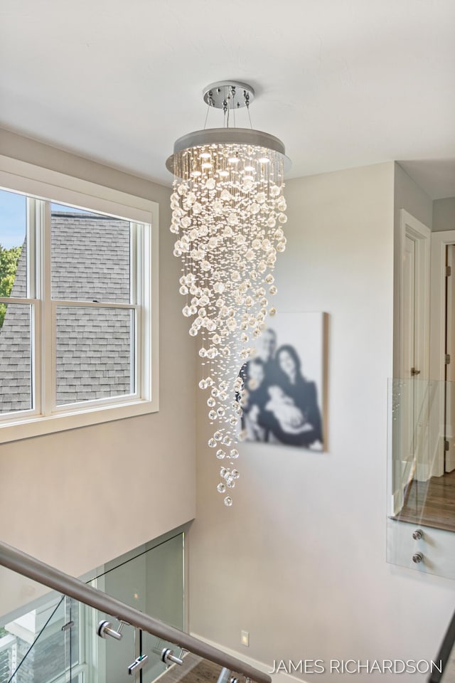 12974 Boulderway Trl, Grand Haven, MI 49417 - stairway featuring a chandelier
