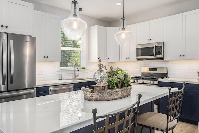 765 S Haven Pl, South Haven, MI 49090 - kitchen with appliances with stainless steel finishes, pendant lighting, a breakfast bar area, backsplash, and recessed lighting