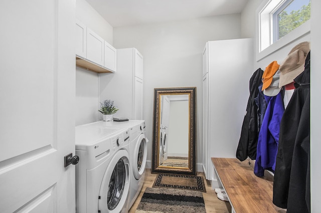 765 S Haven Pl, South Haven, MI 49090 - washroom with independent washer and dryer, light wood finished floors, and cabinet space