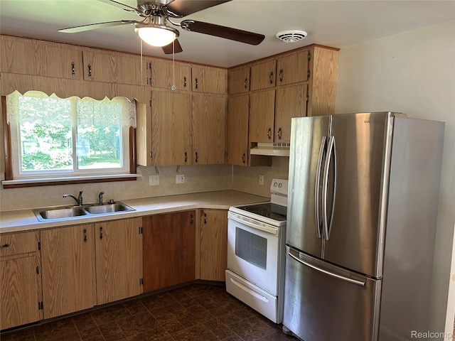 411 N Gould St, Owosso, MI 48867 - kitchen with freestanding refrigerator, electric range, under cabinet range hood, and light countertops